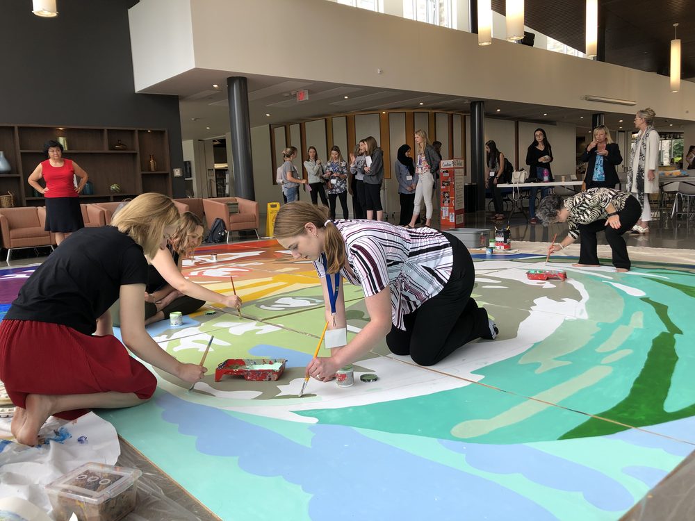People painting the canvas in the atrium