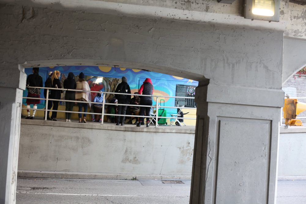 People gathered for the unveiling in the underpass