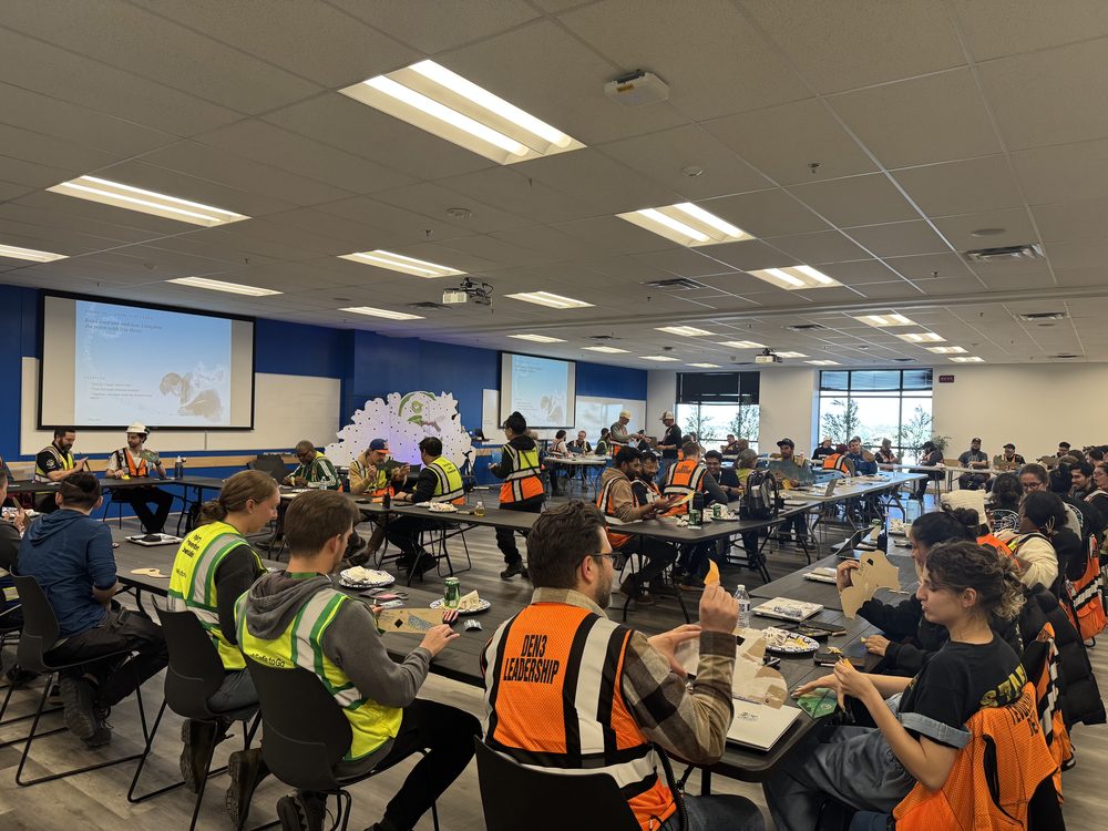 A training room full of leaders at tables