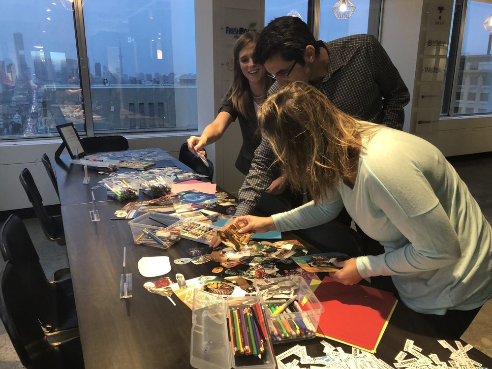 Collage materials laid out on a long table