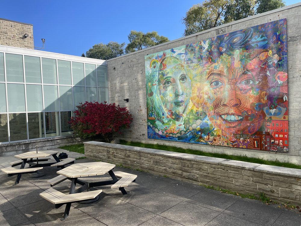 A large co-created mural installed on a building wall