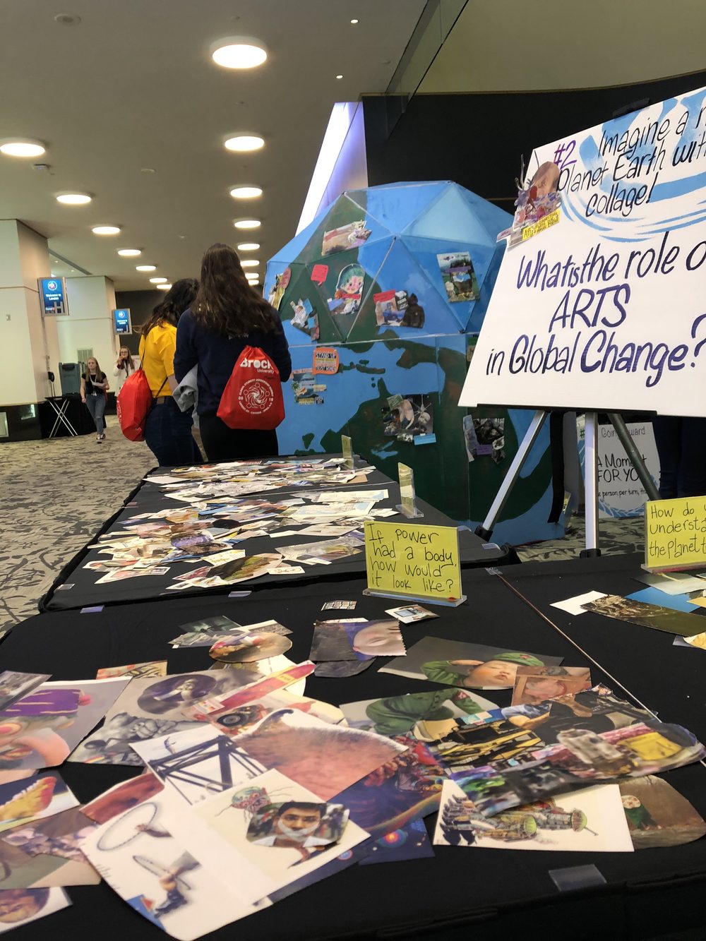 An engagement booth with a collage table and a painted globe